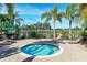 Circular hot tub surrounded by palm trees and lounge chairs at 6422 42Nd E St, Sarasota, FL 34243