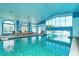 Indoor heated pool with lounge chairs and large windows at 6422 42Nd E St, Sarasota, FL 34243