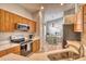 Modern kitchen with stainless steel appliances and light wood cabinets at 6422 42Nd E St, Sarasota, FL 34243