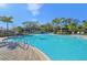 Expansive community pool surrounded by lush tropical landscaping at 6620 Serenity Fall Ln, Sarasota, FL 34240