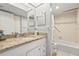 Bathroom with granite countertop, single sink, and bathtub at 6703 Midnight Pass Rd # 108B, Sarasota, FL 34242