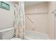 Clean bathroom with tub, shower, and beach-themed decor at 6703 Midnight Pass Rd # 108B, Sarasota, FL 34242