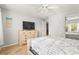 Bedroom with dresser, queen-size bed, and a view of another room at 6703 Midnight Pass Rd # 108B, Sarasota, FL 34242