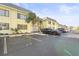 Condo building with parking and palm trees at 6703 Midnight Pass Rd # 108B, Sarasota, FL 34242