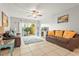Relaxing living room with leather sofas, tile floors and access to patio at 6703 Midnight Pass Rd # 108B, Sarasota, FL 34242