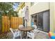 Cozy patio area with a table, chairs, and umbrella at 6703 Midnight Pass Rd # 108B, Sarasota, FL 34242