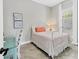 Small bedroom with a white metal bed frame and desk at 7036 Whittlebury Trl, Bradenton, FL 34202