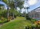 Landscaped backyard with lush greenery and a relaxing pool area at 7207 Saint Johns Way, University Park, FL 34201