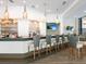 Upscale bar with stylish pendant lights and gray barstools at 7207 Saint Johns Way, University Park, FL 34201