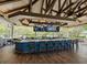 Rustic bar with wicker chairs and large TVs at 7207 Saint Johns Way, University Park, FL 34201