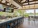 Bright bar with wicker chairs and views of the golf course at 7207 Saint Johns Way, University Park, FL 34201