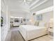 Bright and airy primary bedroom with a king-size bed, built-in cabinets, and large windows at 7207 Saint Johns Way, University Park, FL 34201
