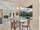 Bright breakfast nook with glass table and pool view at 7207 Saint Johns Way, University Park, FL 34201