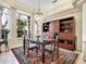 Formal dining room with a wood hutch, chandelier, and large windows at 7207 Saint Johns Way, University Park, FL 34201