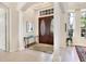 Bright entryway with double doors, columns, and a glass-top console table at 7207 Saint Johns Way, University Park, FL 34201