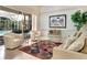 Gathering room with pool view, comfy seating, and a large picture window at 7207 Saint Johns Way, University Park, FL 34201