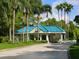 Gated community entrance with guard house and palm trees at 7207 Saint Johns Way, University Park, FL 34201