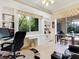 Bright home office features built-in shelving, pool view, and ample workspace at 7207 Saint Johns Way, University Park, FL 34201