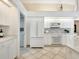 Kitchen boasts white cabinets and stainless steel appliances at 7207 Saint Johns Way, University Park, FL 34201