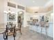 Kitchen with white cabinets, breakfast bar, and island at 7207 Saint Johns Way, University Park, FL 34201