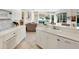 White kitchen features quartz counters and stainless steel appliances at 7207 Saint Johns Way, University Park, FL 34201