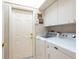 Convenient laundry room with washer, dryer, and extra storage at 7207 Saint Johns Way, University Park, FL 34201