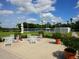 Relaxing patio furniture near tennis courts at 7207 Saint Johns Way, University Park, FL 34201