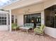 Peaceful patio with seating area, adjacent to the pool and screened enclosure at 7207 Saint Johns Way, University Park, FL 34201
