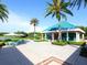 Outdoor patio seating area with palm trees and pond view at 7207 Saint Johns Way, University Park, FL 34201