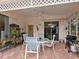 Relaxing patio with seating area and lush landscaping, great for outdoor dining at 7207 Saint Johns Way, University Park, FL 34201