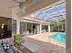 Covered patio overlooking the pool and spa, furnished with comfortable seating at 7207 Saint Johns Way, University Park, FL 34201