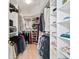Large walk-in closet with custom shelving and plenty of storage space at 7207 Saint Johns Way, University Park, FL 34201