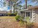 Screened patio and grassy backyard with lush landscaping at 727 N Jefferson Ave # 727, Sarasota, FL 34237