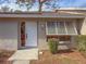 Front entrance of a tan house with white door and shutters at 727 N Jefferson Ave # 727, Sarasota, FL 34237