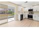 Modern kitchen with white cabinets, stainless steel appliances, and light wood floors at 727 N Jefferson Ave # 727, Sarasota, FL 34237
