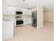 Modern kitchen with white cabinets, stainless steel appliances, and light wood floors at 727 N Jefferson Ave # 727, Sarasota, FL 34237
