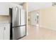 Modern kitchen with white cabinets, stainless steel appliances, and light wood floors at 727 N Jefferson Ave # 727, Sarasota, FL 34237