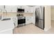 Modern kitchen with white cabinets, stainless steel appliances, and light wood floors at 727 N Jefferson Ave # 727, Sarasota, FL 34237