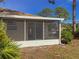 Cozy screened porch with sliding glass doors and view of backyard at 727 N Jefferson Ave # 727, Sarasota, FL 34237