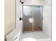 Walk-in shower with marble tile and sliding glass door at 727 N Jefferson Ave # 727, Sarasota, FL 34237