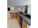 Kitchen with large island, granite counters and wood cabinets at 732 Tuxford Dr, Sarasota, FL 34232