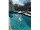 Inviting swimming pool with stone deck and patio furniture at 732 Tuxford Dr, Sarasota, FL 34232