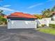 White garage door and walkway, featuring a red tile roof at 758 Sarabay Rd # 5, Osprey, FL 34229