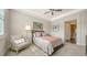 Bedroom with a comfy bed, armchair, and en-suite bathroom at 7668 Registrar Way, Sarasota, FL 34243