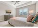 Comfortable bedroom with a queen-size bed and a wall-mounted TV at 7668 Registrar Way, Sarasota, FL 34243
