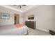 Bright bedroom with a cozy bed, dresser, and large TV at 7668 Registrar Way, Sarasota, FL 34243