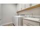 Laundry room with washer, dryer, and utility sink at 7668 Registrar Way, Sarasota, FL 34243