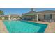 Resort-style pool with covered seating at 7668 Registrar Way, Sarasota, FL 34243