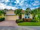 Beautiful yellow house with palm trees and a brick driveway at 7708 31St E St, Sarasota, FL 34243