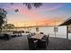 Large backyard with dining area, fire pit, and string lights at 8204 Constance Dr, Sarasota, FL 34243